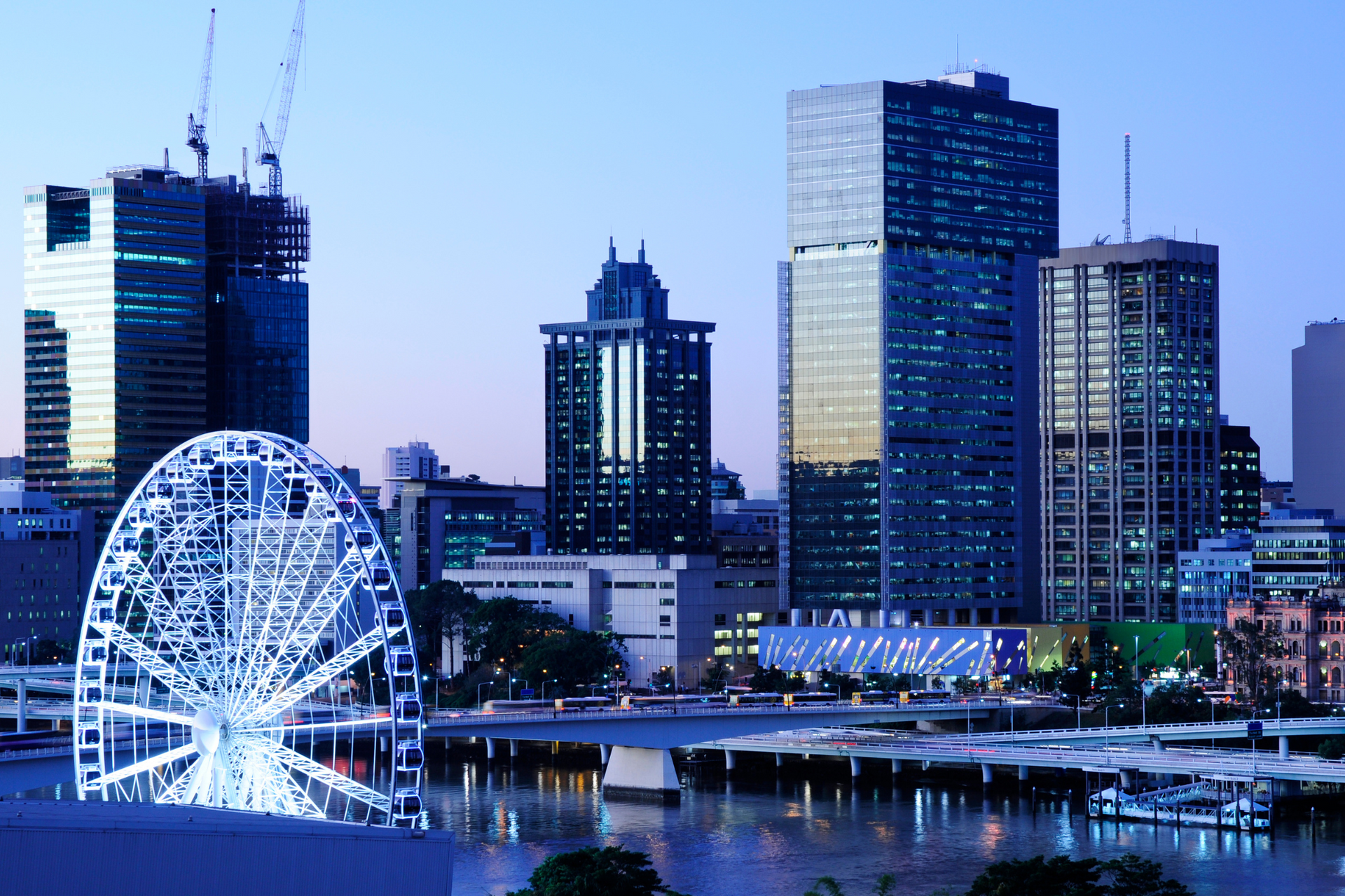 A city skyline with a ferris wheel in the foreground