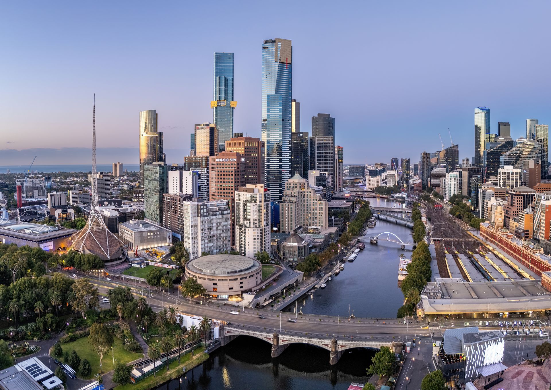 An aerial view of a city with a river and a bridge.