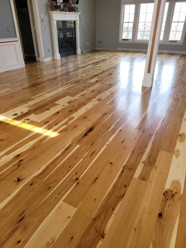 a living room with hardwood floors and a fireplace