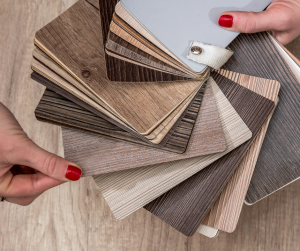 a woman is holding a swatch of wood samples in their hands