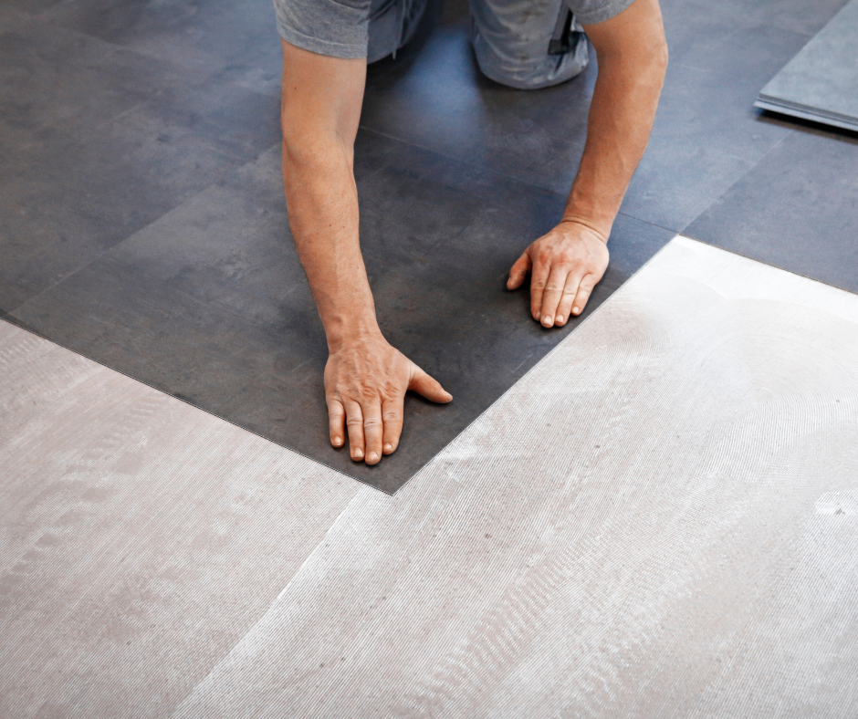 a man is installing an LVT floor in a room