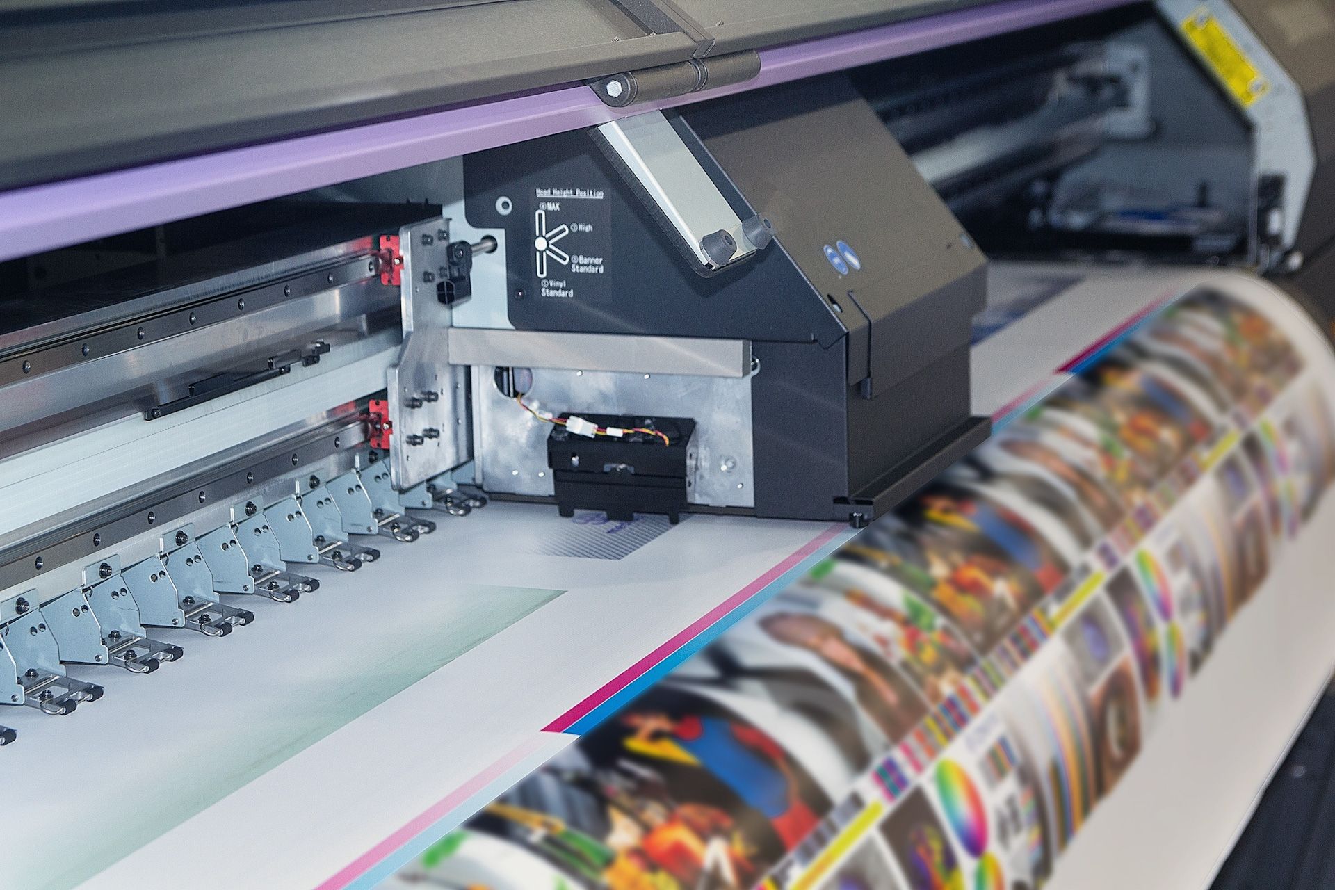 A large roll of paper is being printed on a large printer.