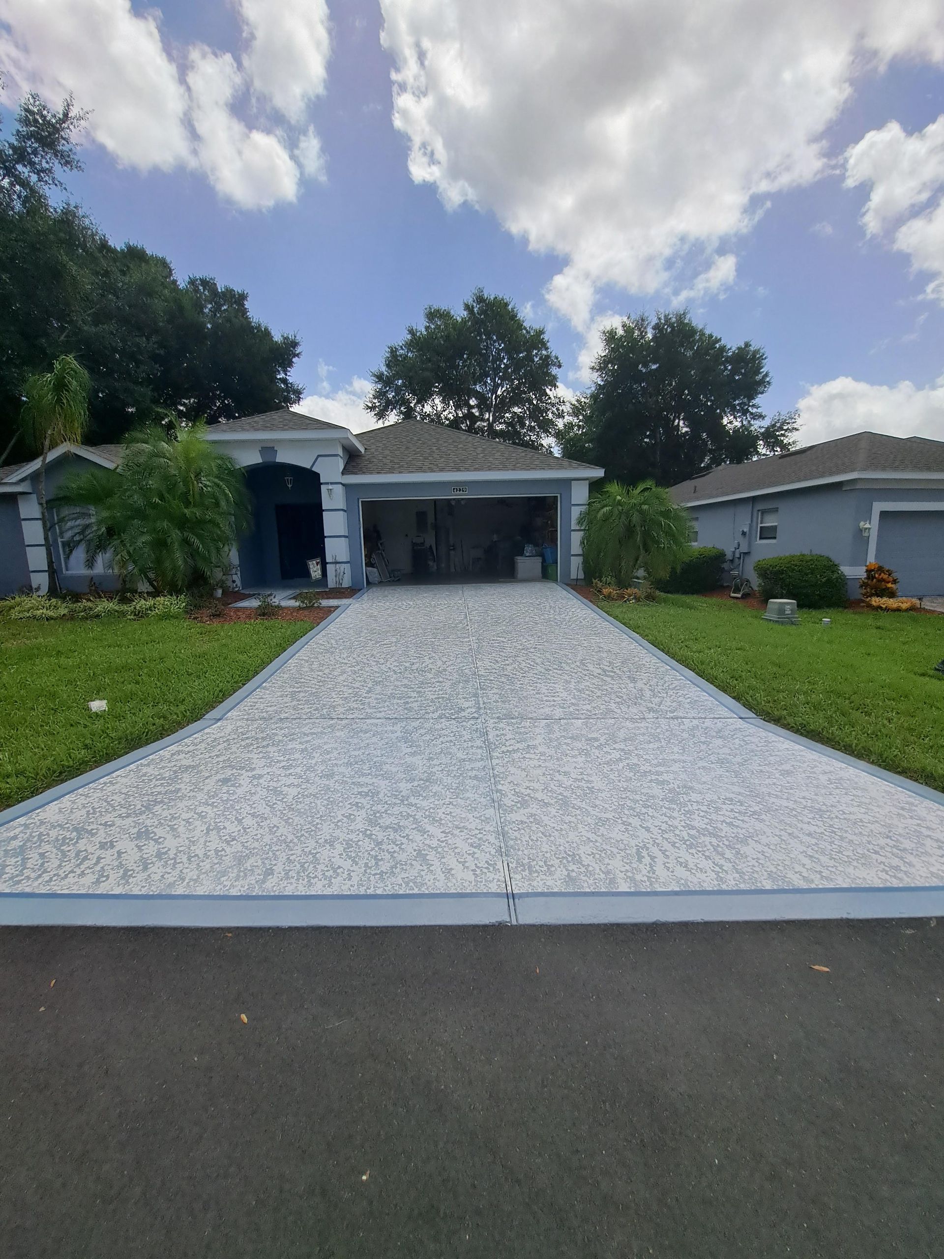A house with a driveway leading to it and a garage.