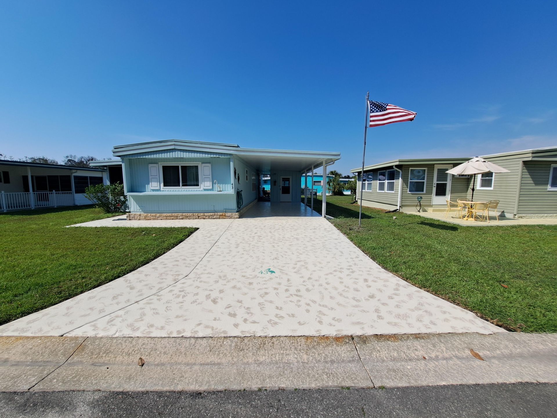 A mobile home with an american flag in front of it