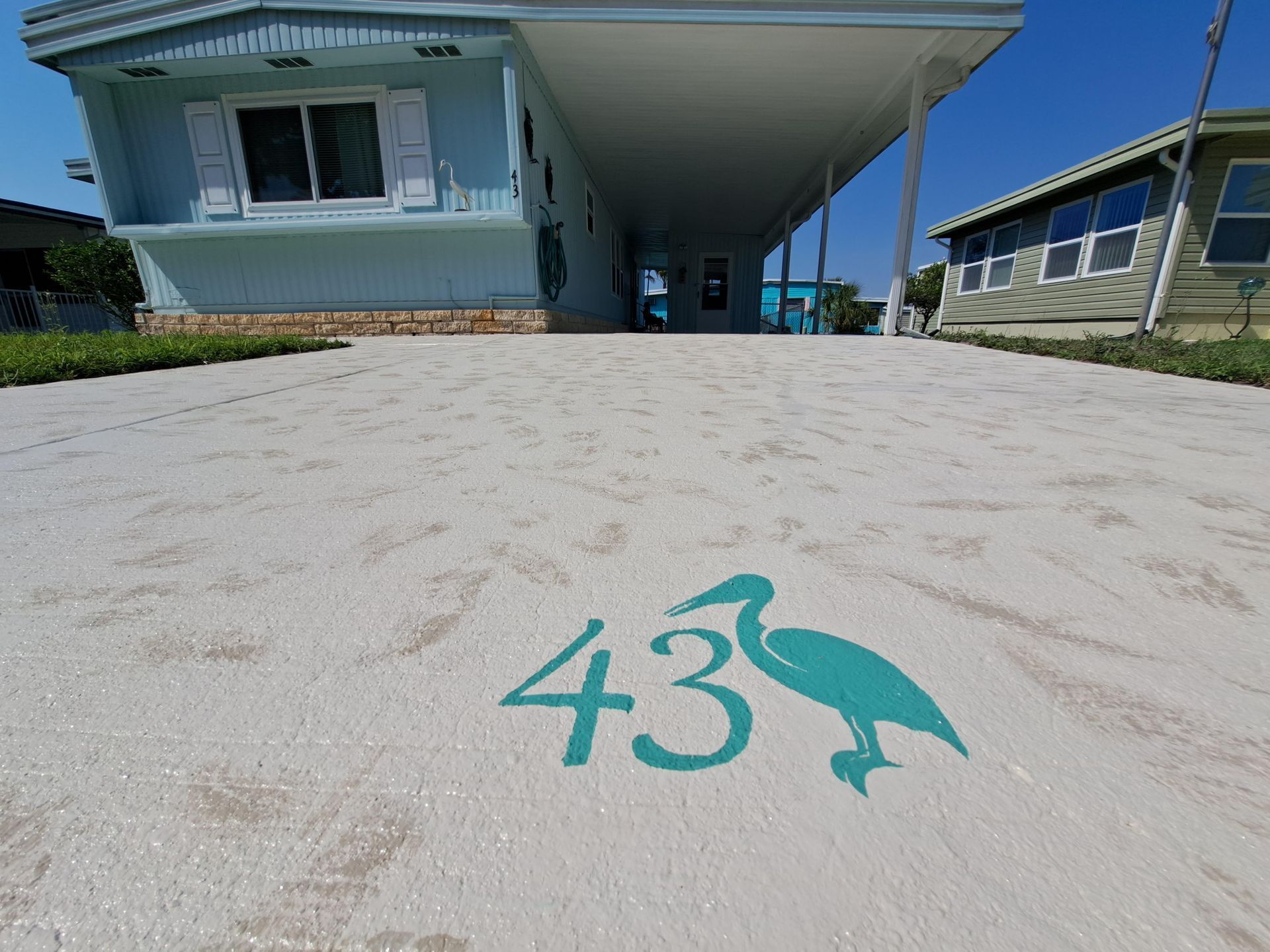 A house with the number 43 painted on the driveway