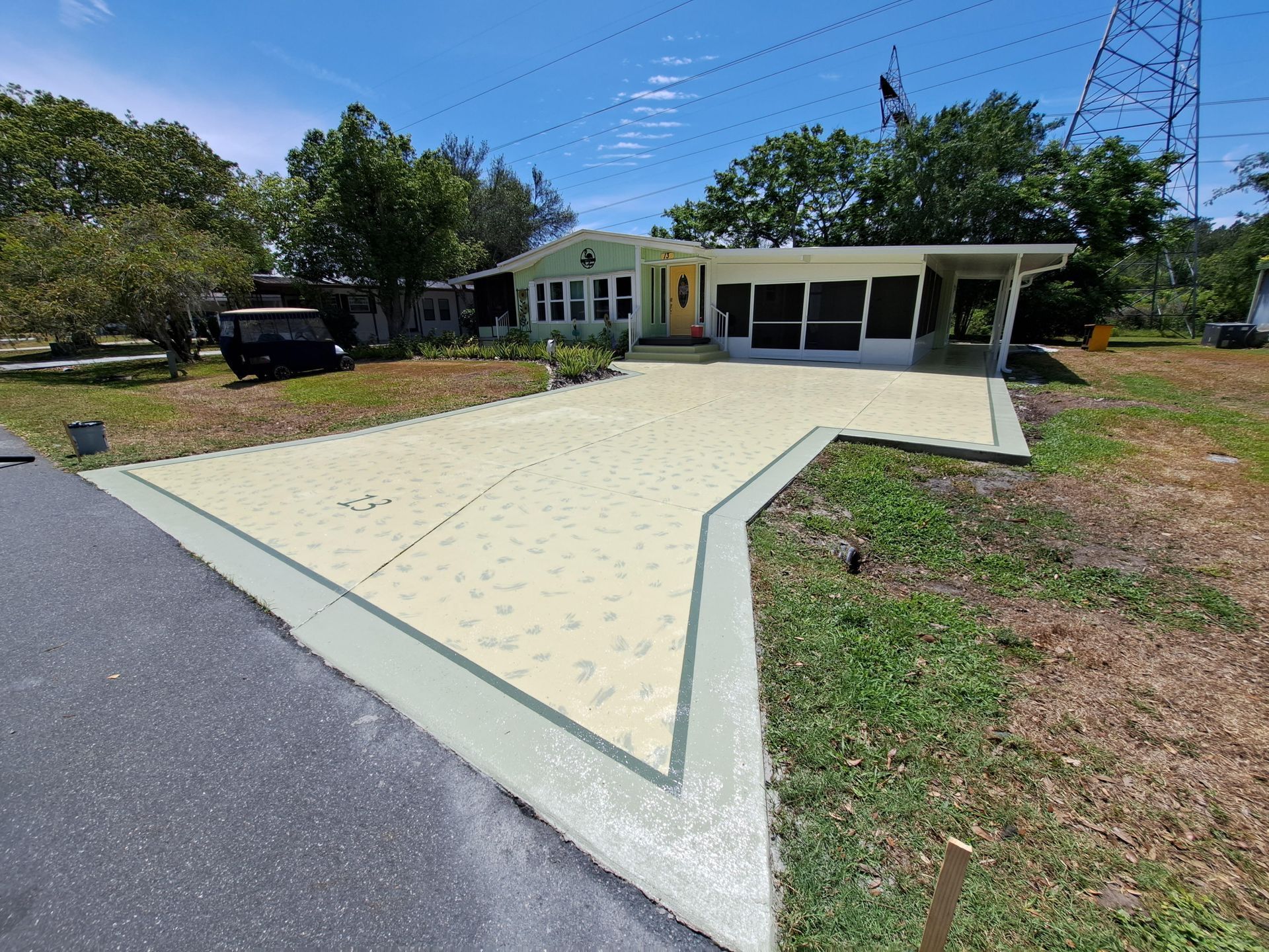 A house with a concrete driveway in front of it