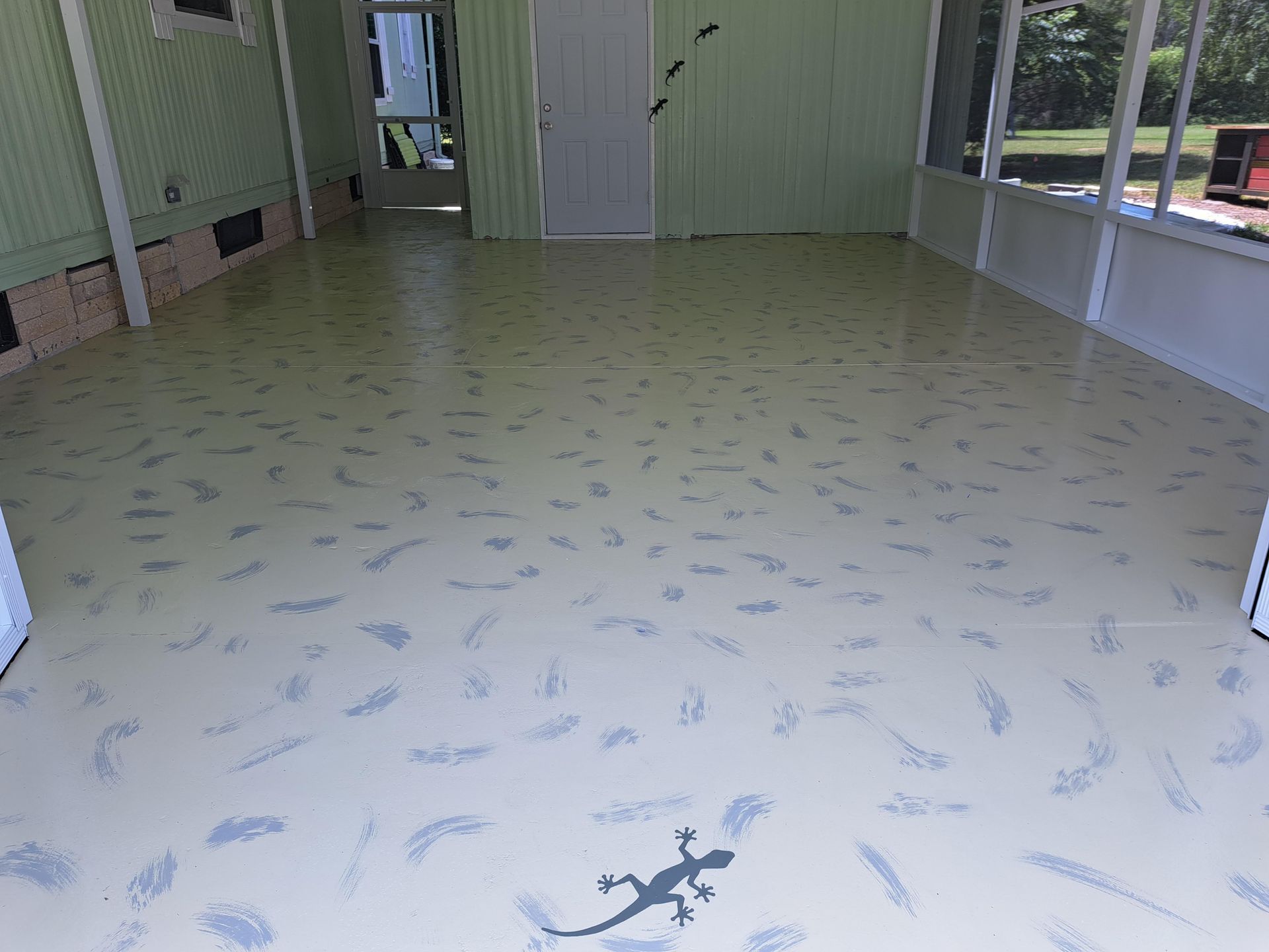 There is a lizard on the floor of the room.