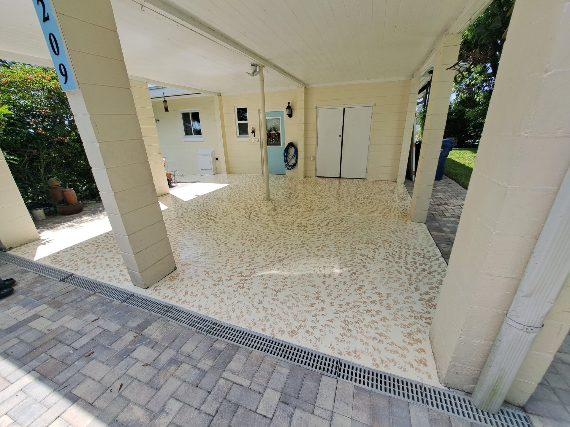 A garage with a concrete floor and a refrigerator.