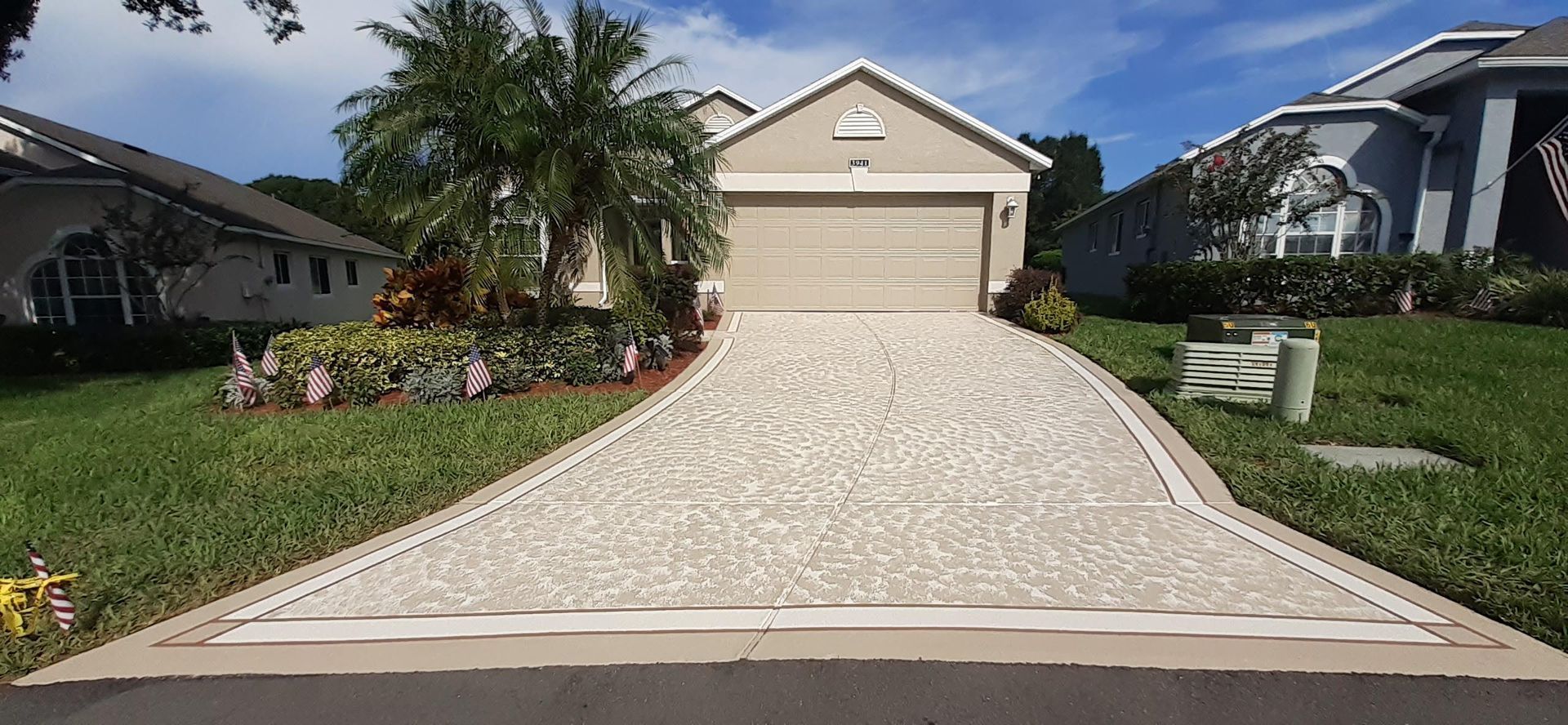 A driveway leading to a house with a garage.