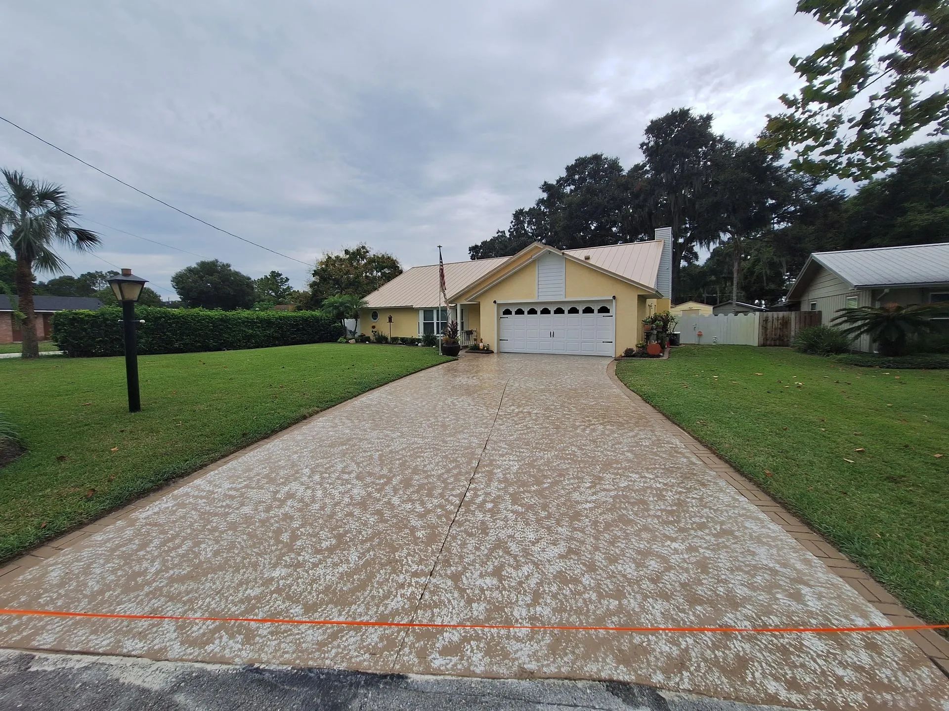 A driveway leading to a house with a garage.