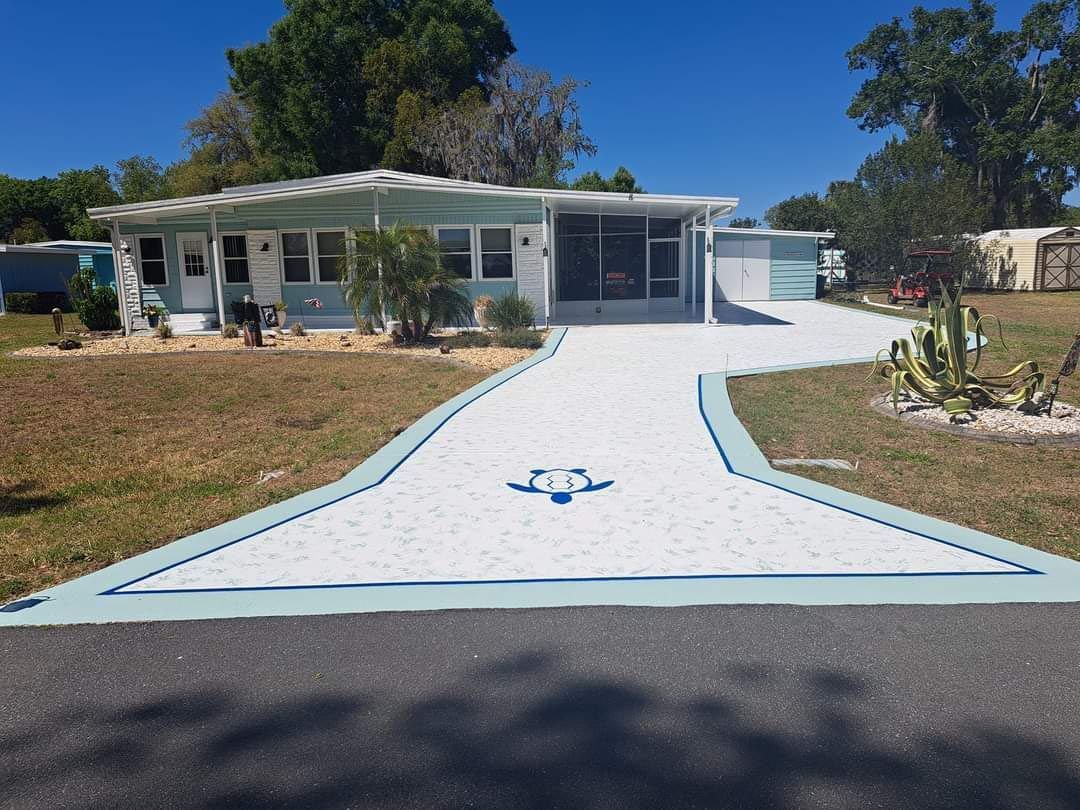 A house with a white driveway and a blue arrow painted on it.