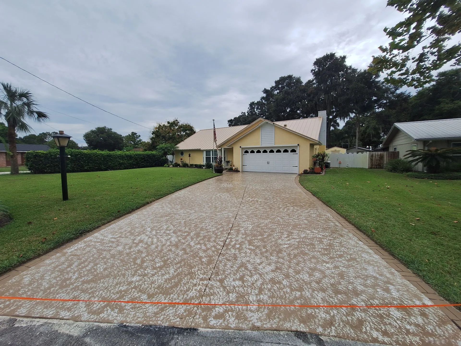 A driveway leading to a house with a garage.