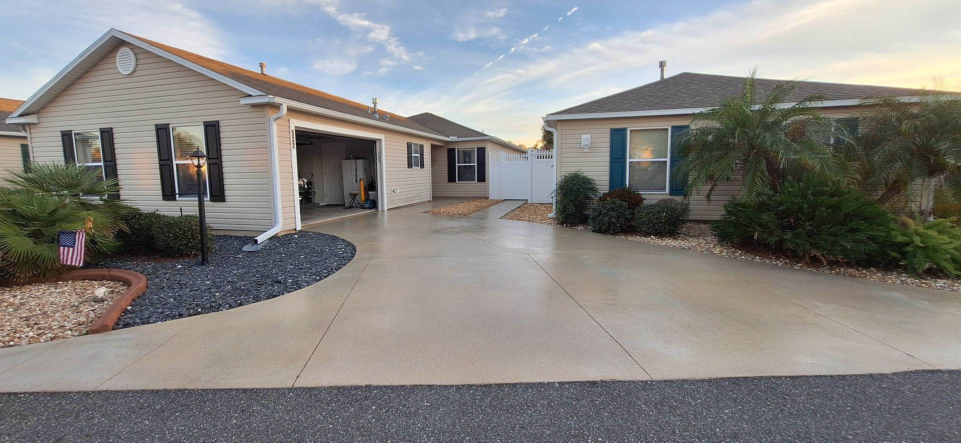 A house with a garage and a driveway in front of it.