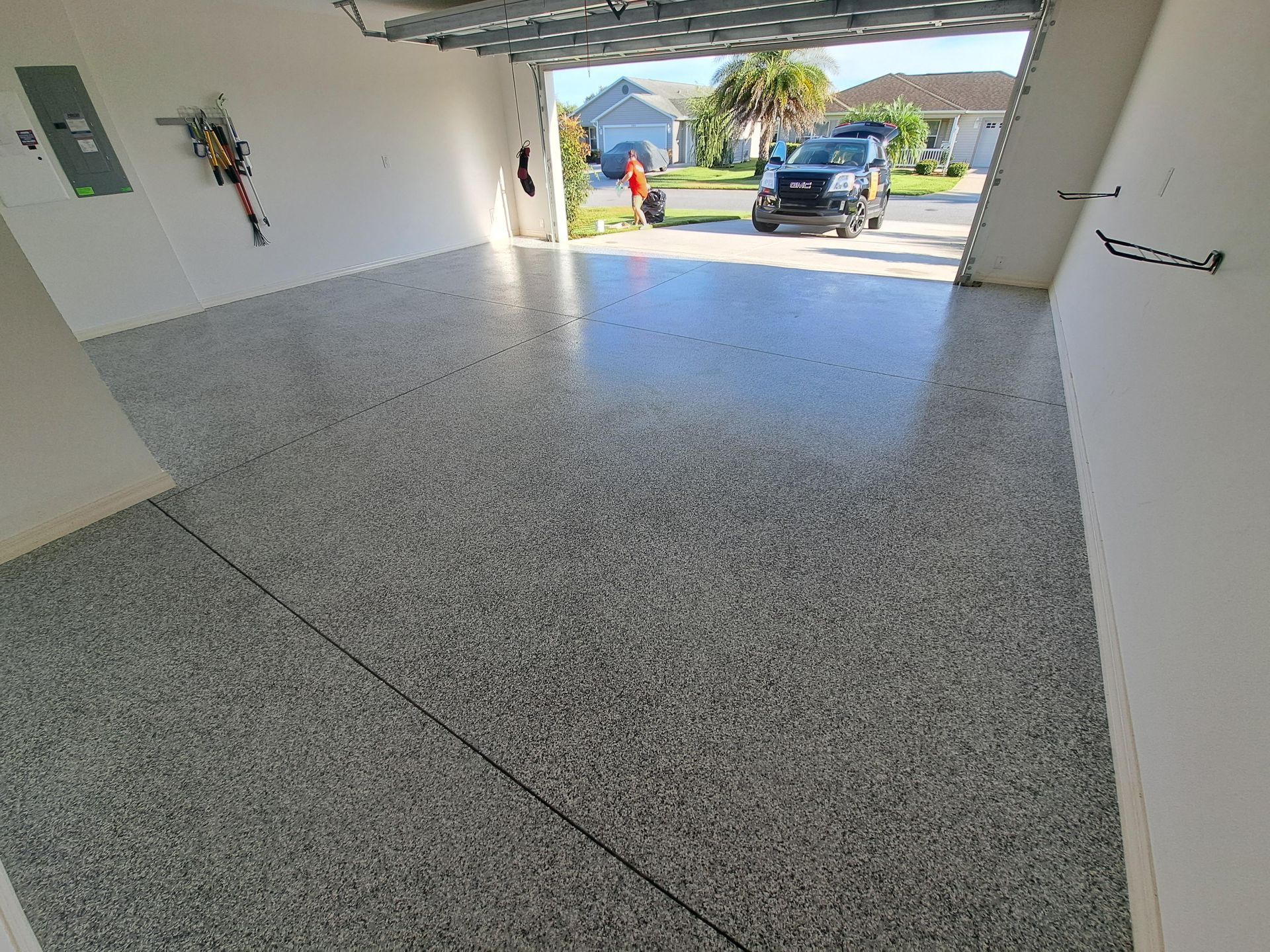 A car is parked in a garage with the door open.