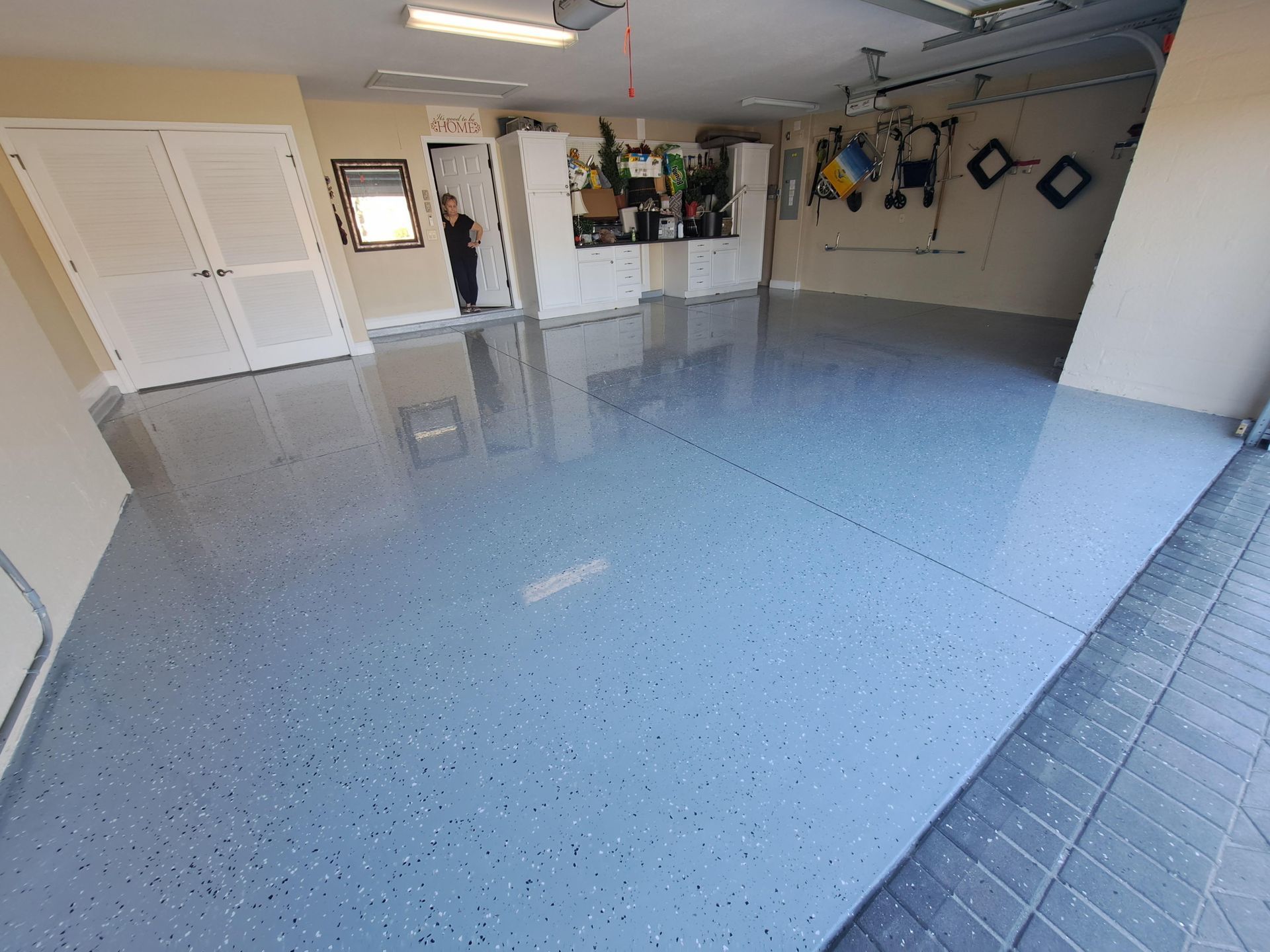 A garage with a gray floor and white walls.