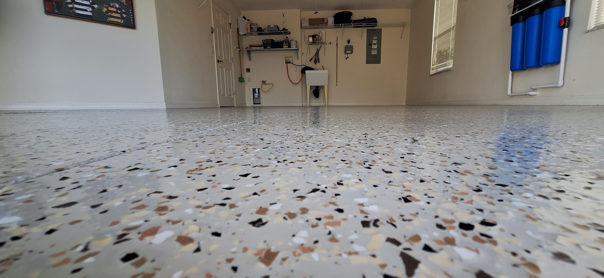 A room with a marble floor and a sink in it.