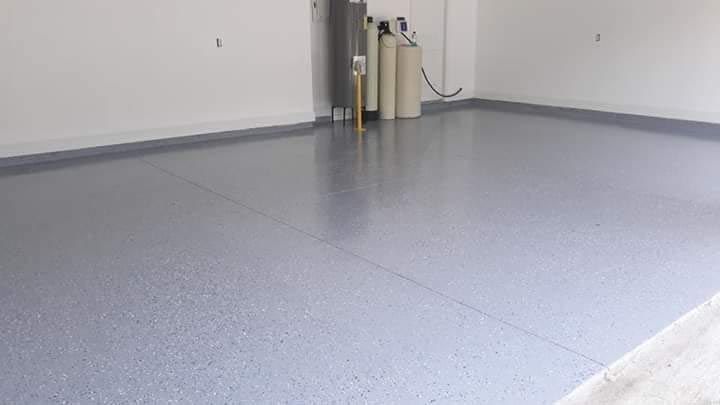 A garage with a gray floor and white walls.