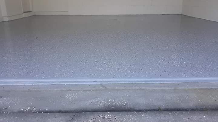 A close up of a gray concrete floor in a garage.