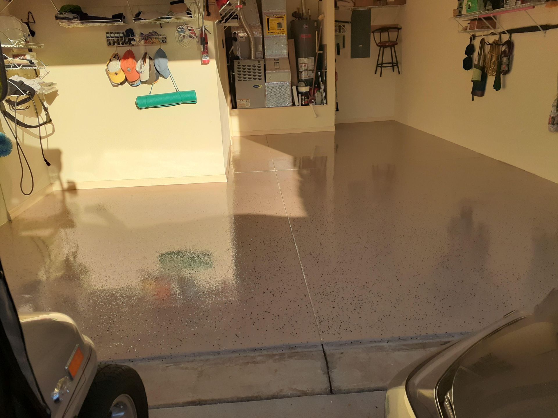 A golf cart is parked in a garage with a shiny floor.