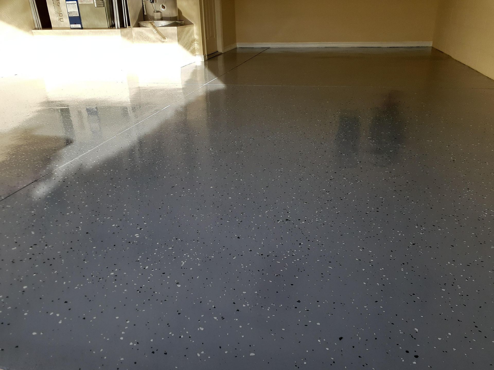 A garage floor with a lot of small dots on it