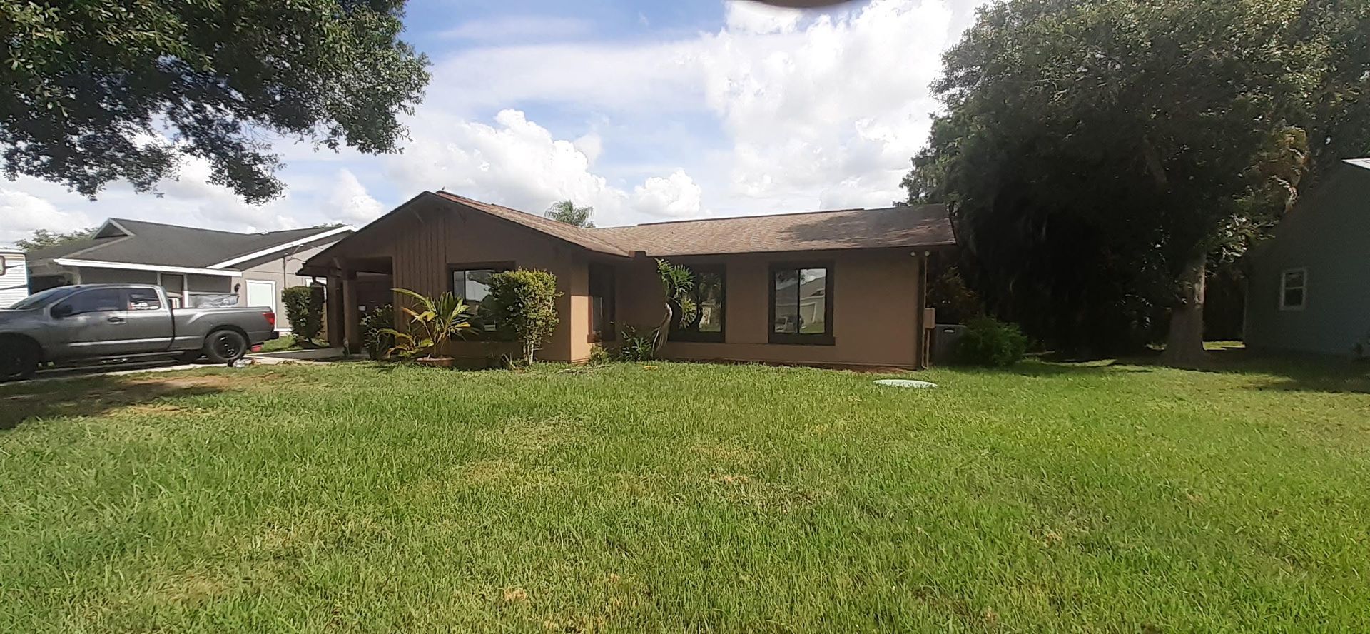 A house with a lot of grass in front of it.