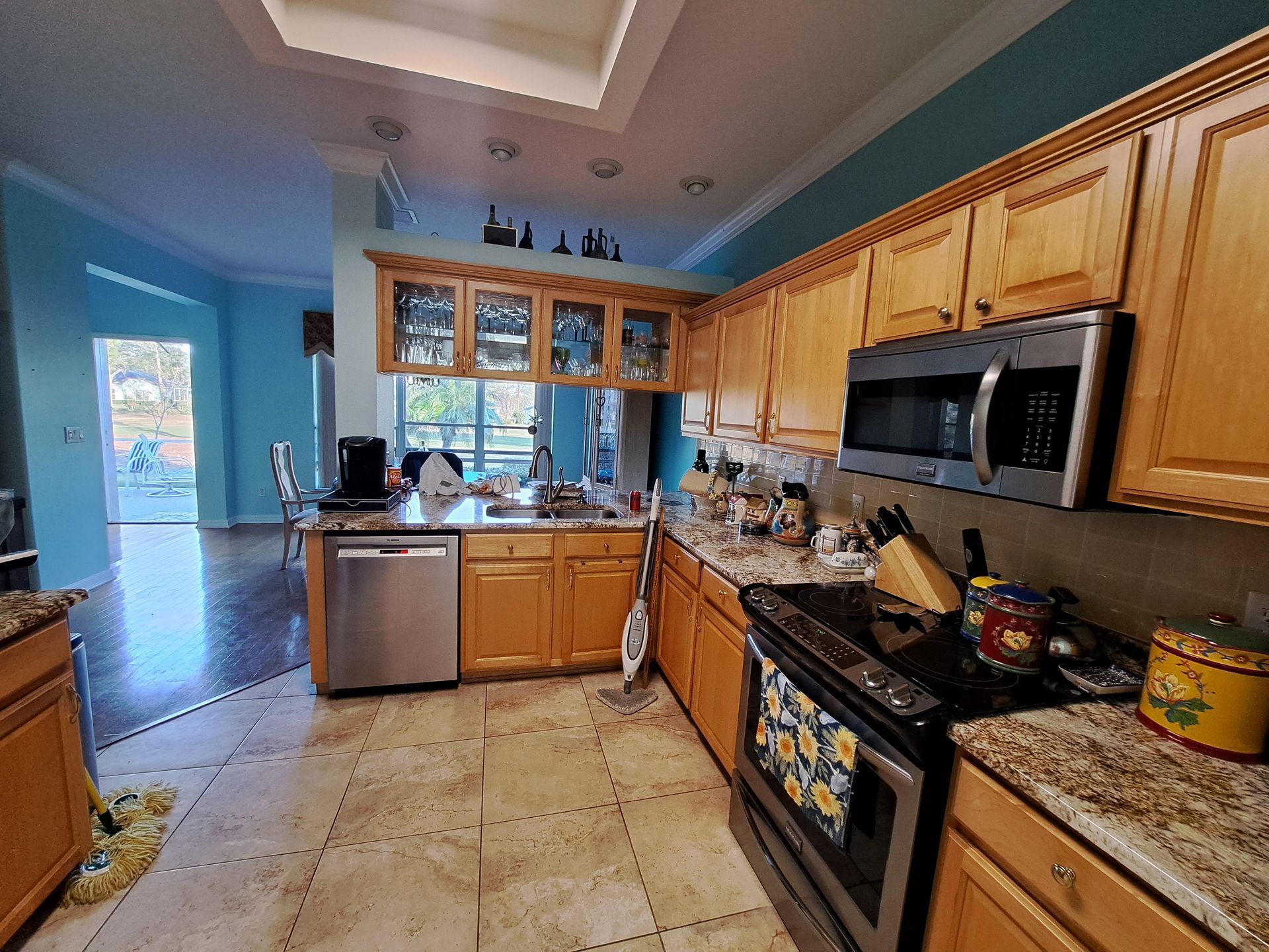 A kitchen with wooden cabinets and stainless steel appliances