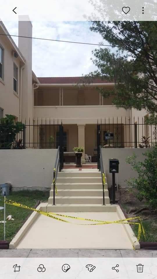 A picture of a house with stairs leading up to it.