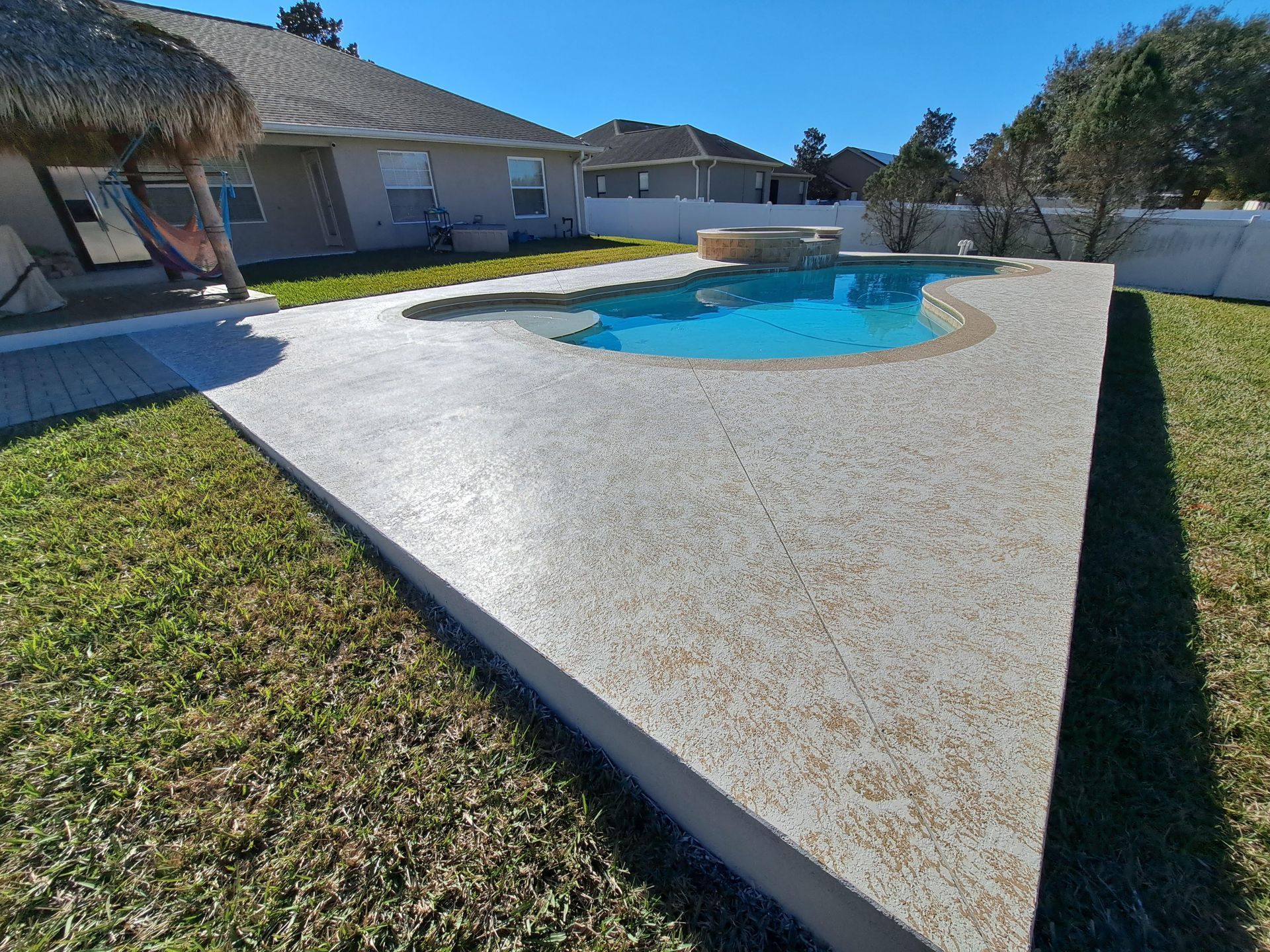 A swimming pool in the backyard of a house