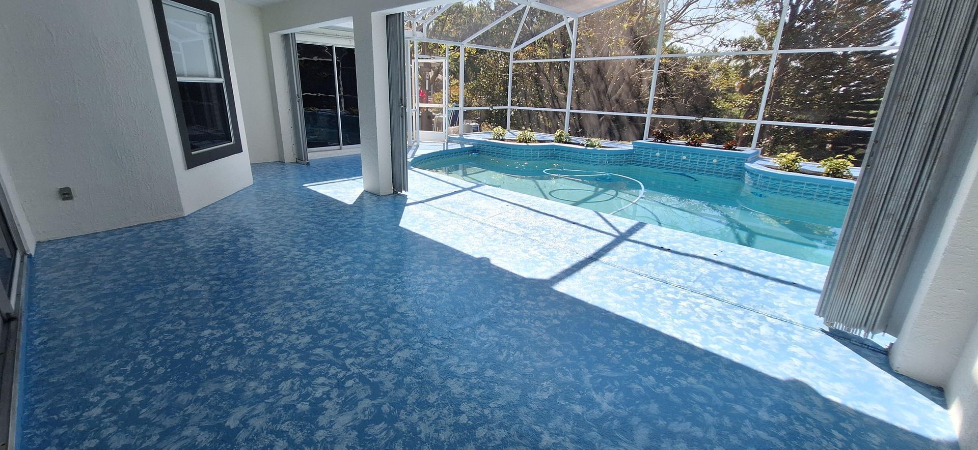 A large room with a swimming pool in the background.