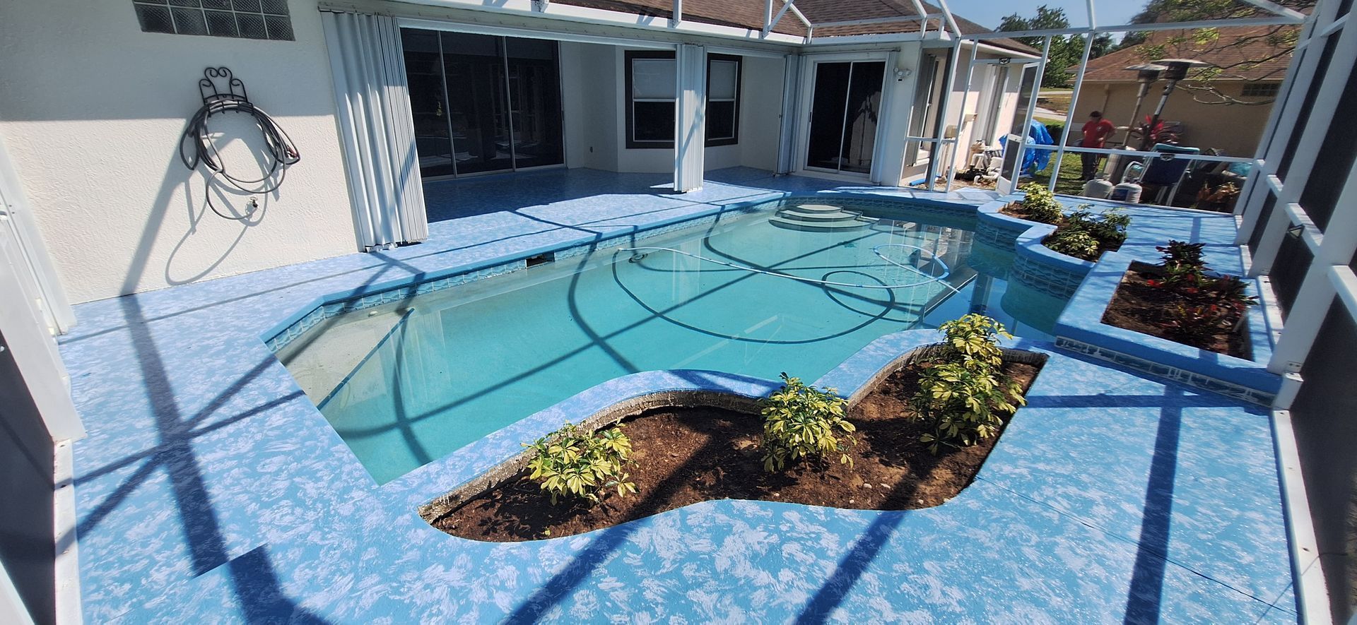 A large swimming pool in the backyard of a house.