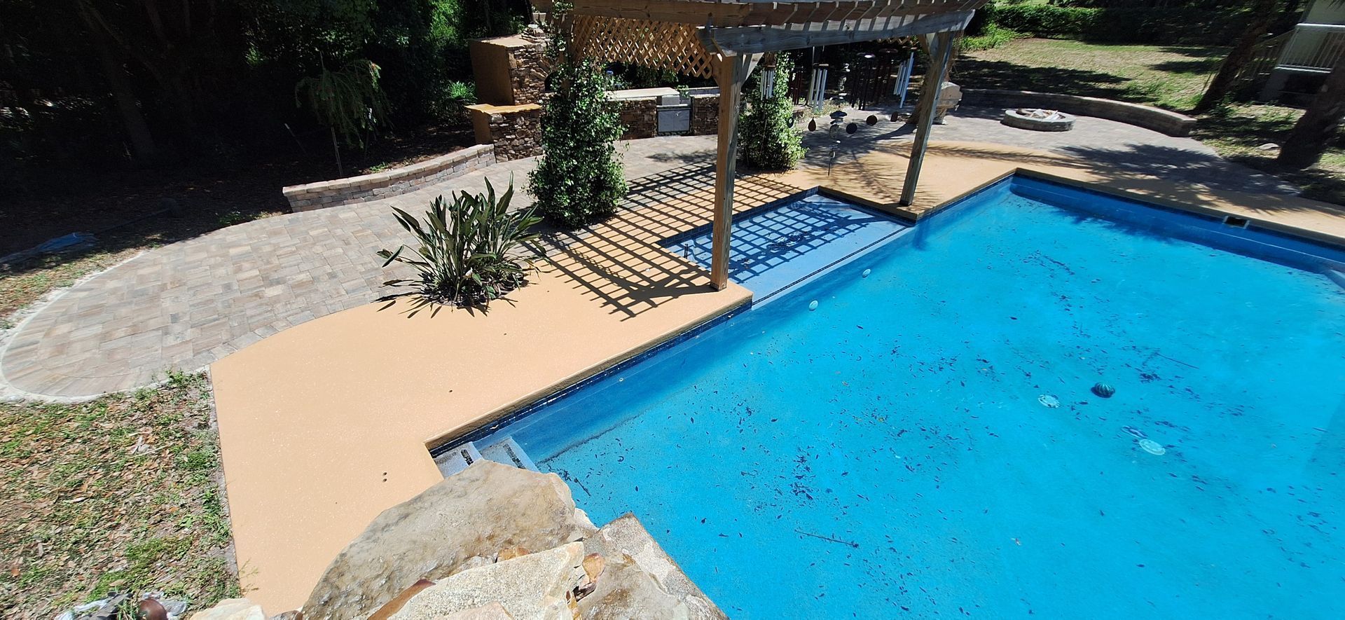 An aerial view of a large swimming pool in a backyard.