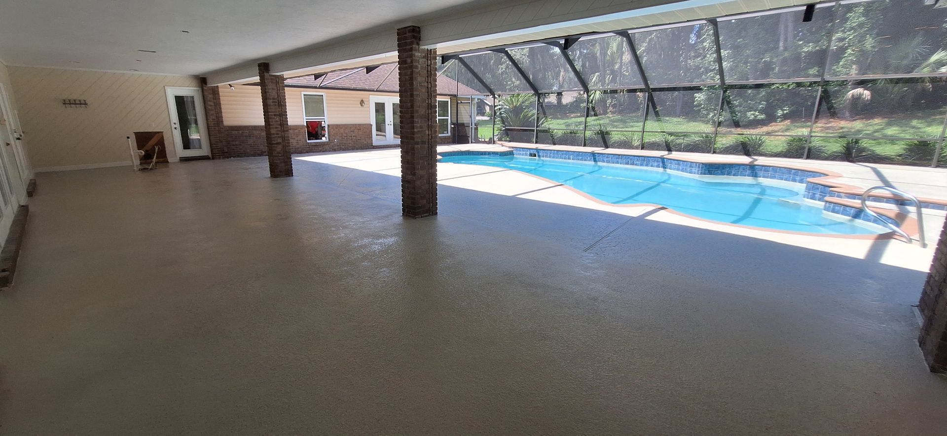 There is a large swimming pool in the backyard of a house.
