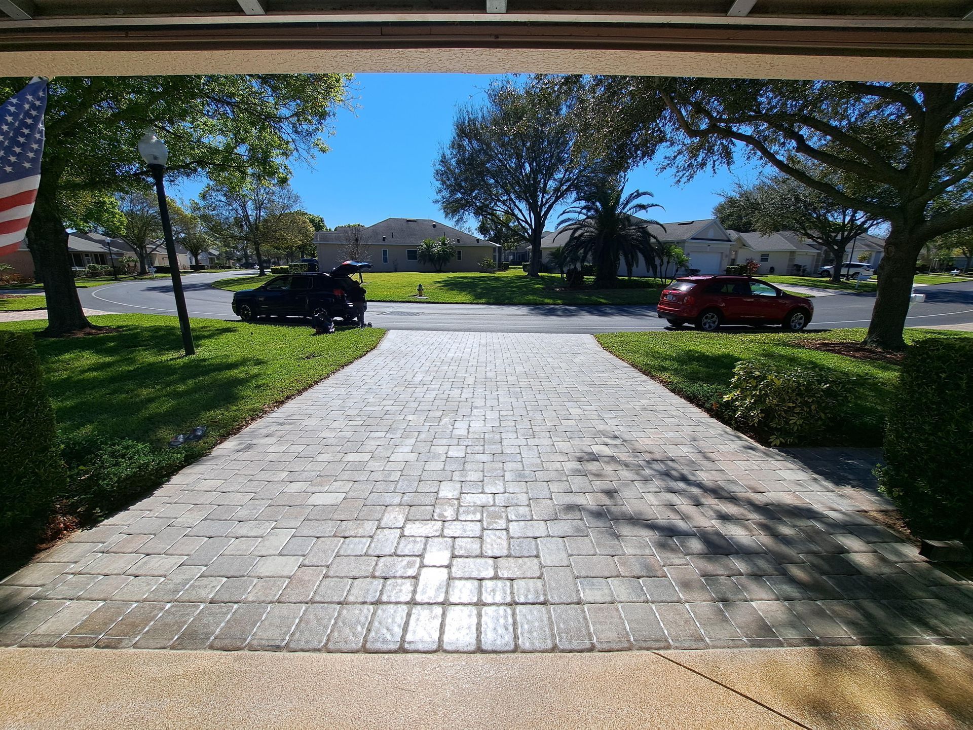 A car is parked in the driveway of a house.