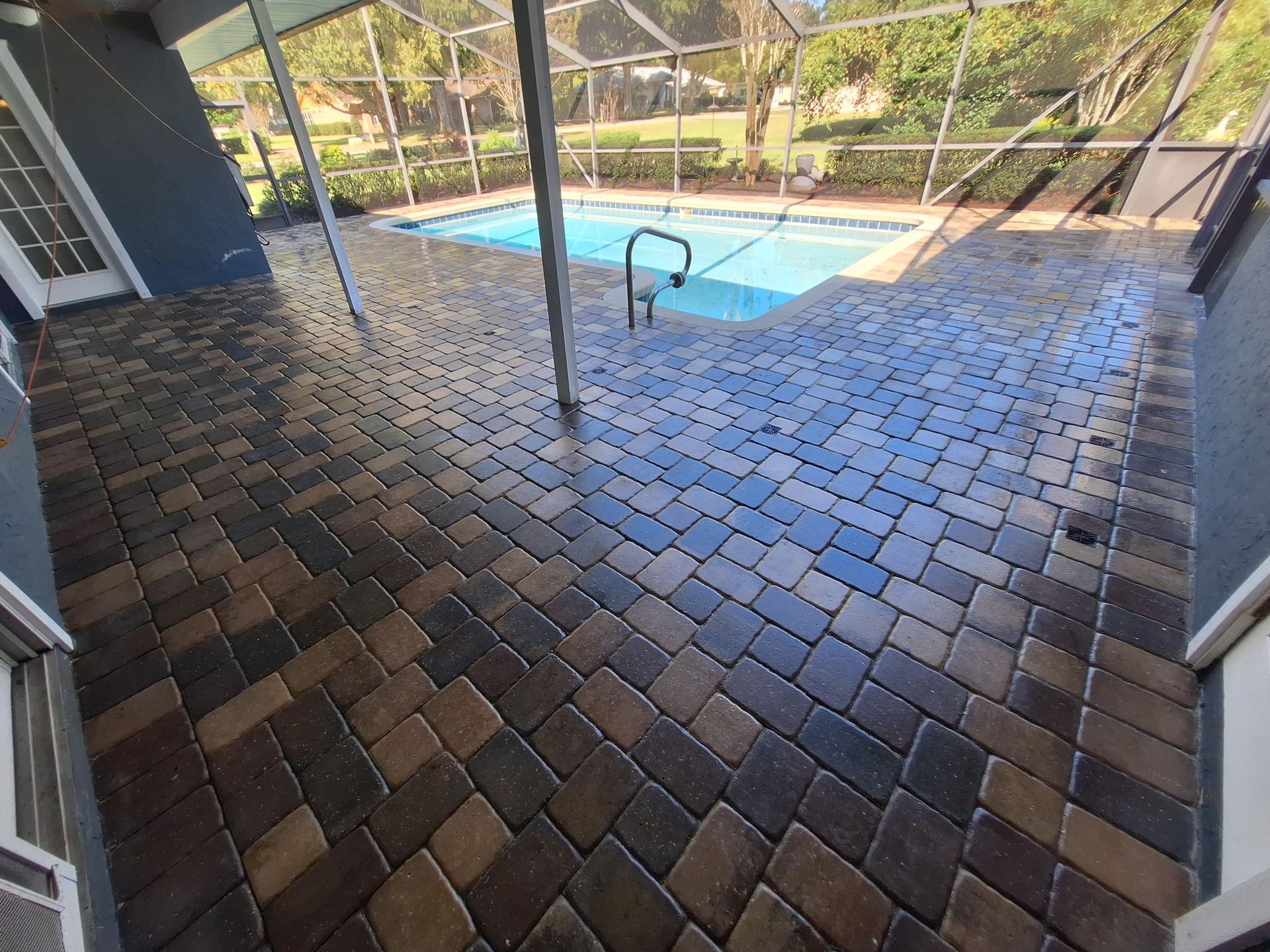 A patio with a swimming pool in the background.