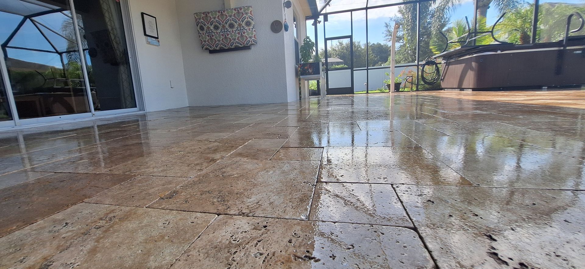 A patio with a tiled floor and a sliding glass door.