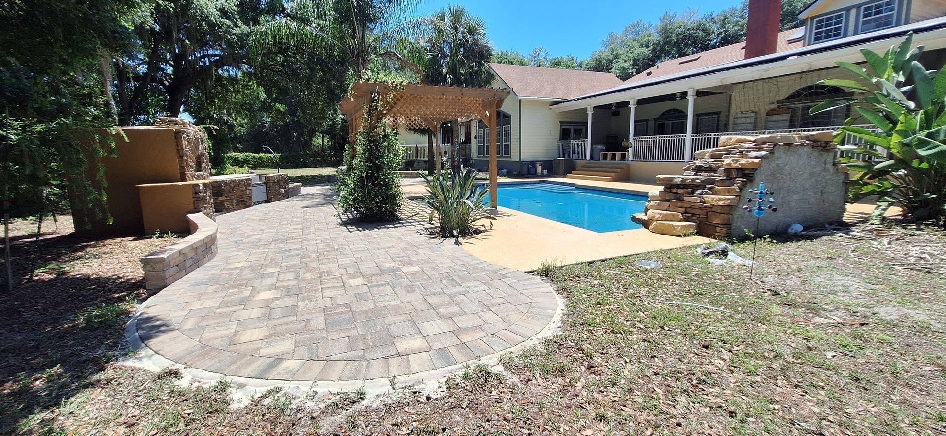 A large house with a swimming pool in front of it