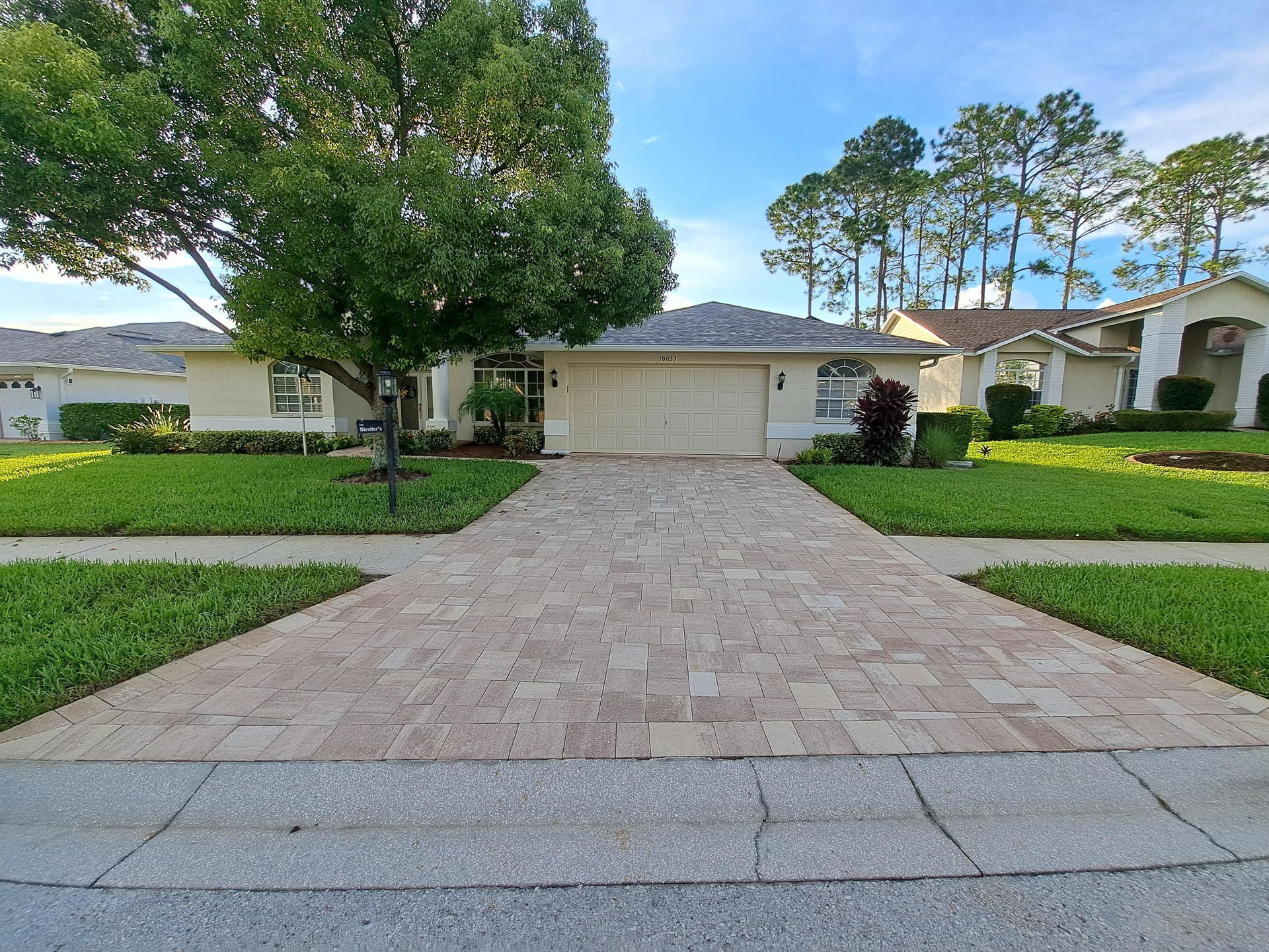 A house with a brick driveway leading to it
