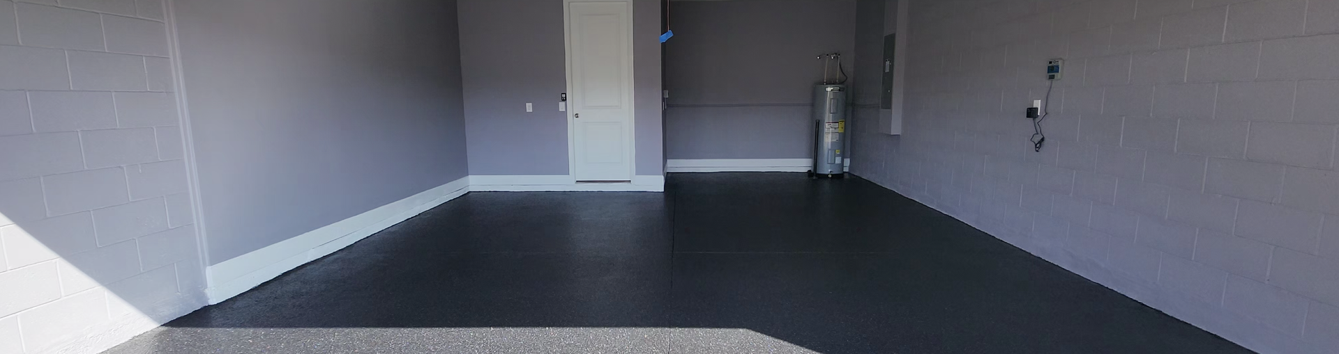 A driveway leading to a mobile home with a concrete walkway.