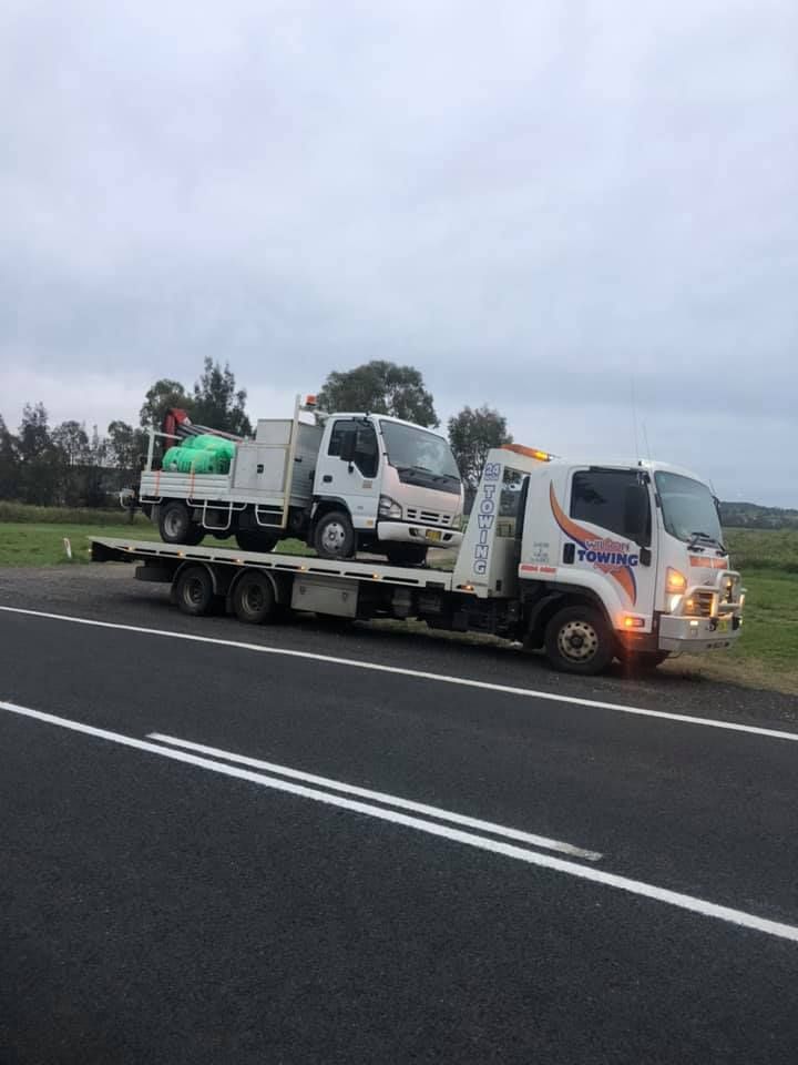 Tow truck picking up and towing old broken down car — Tow in Dubbo, NSW