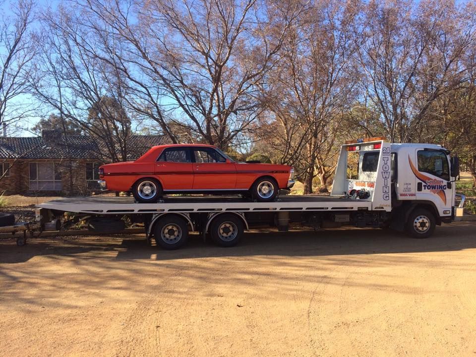 Orange Sedan Vehicle on Board in Towing Truck — Tow in Dubbo, NSW