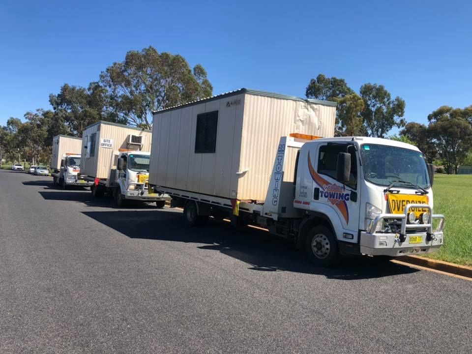 Truck driver standing by container truck — Tow in Forbes, NSW