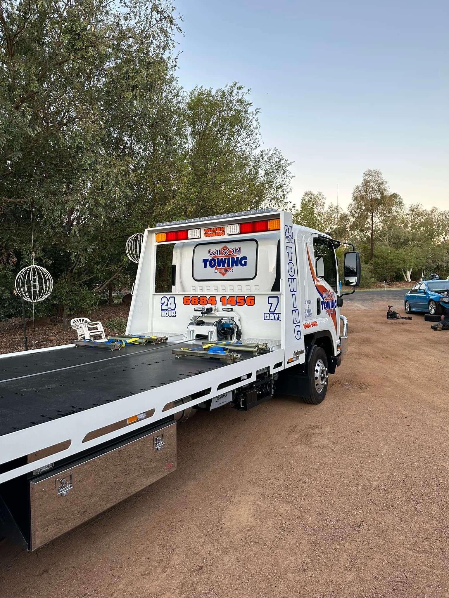 Towing Truck With Flatbed Parked On A Road
