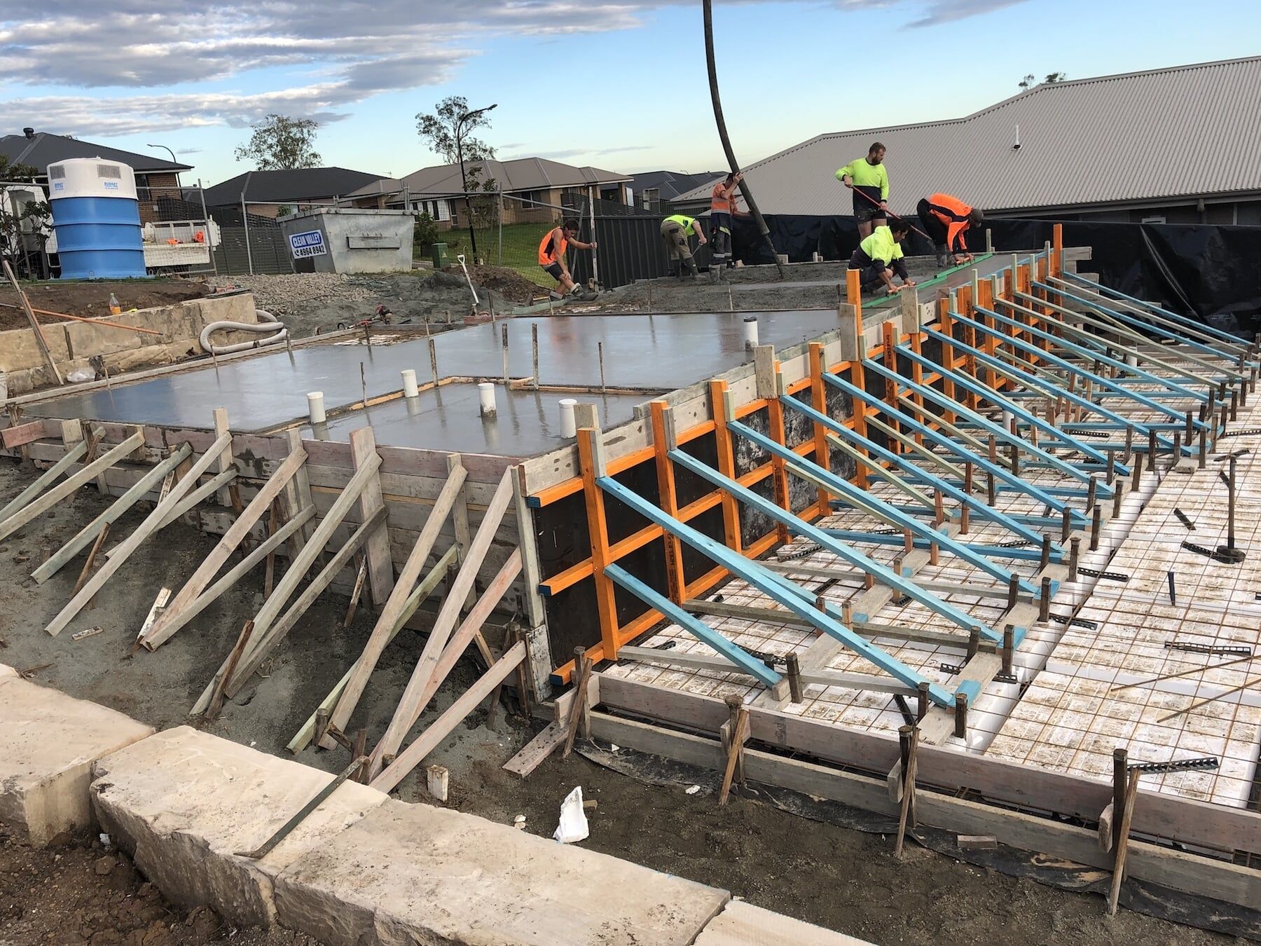 Workers Pouring And Levelling Concrete — Concreting in Tanilba Bay, NSW