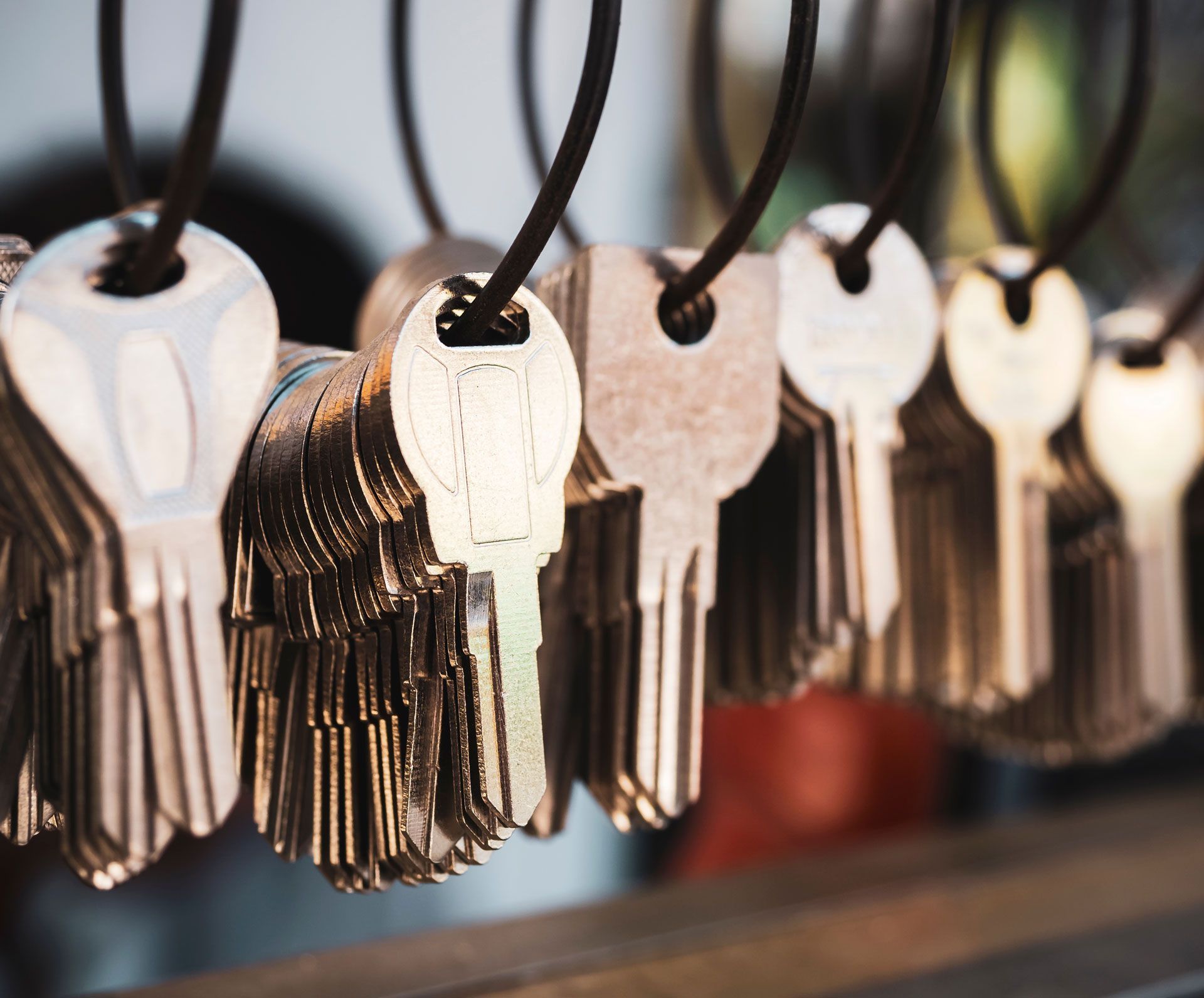 A bunch of keys hanging on a string.