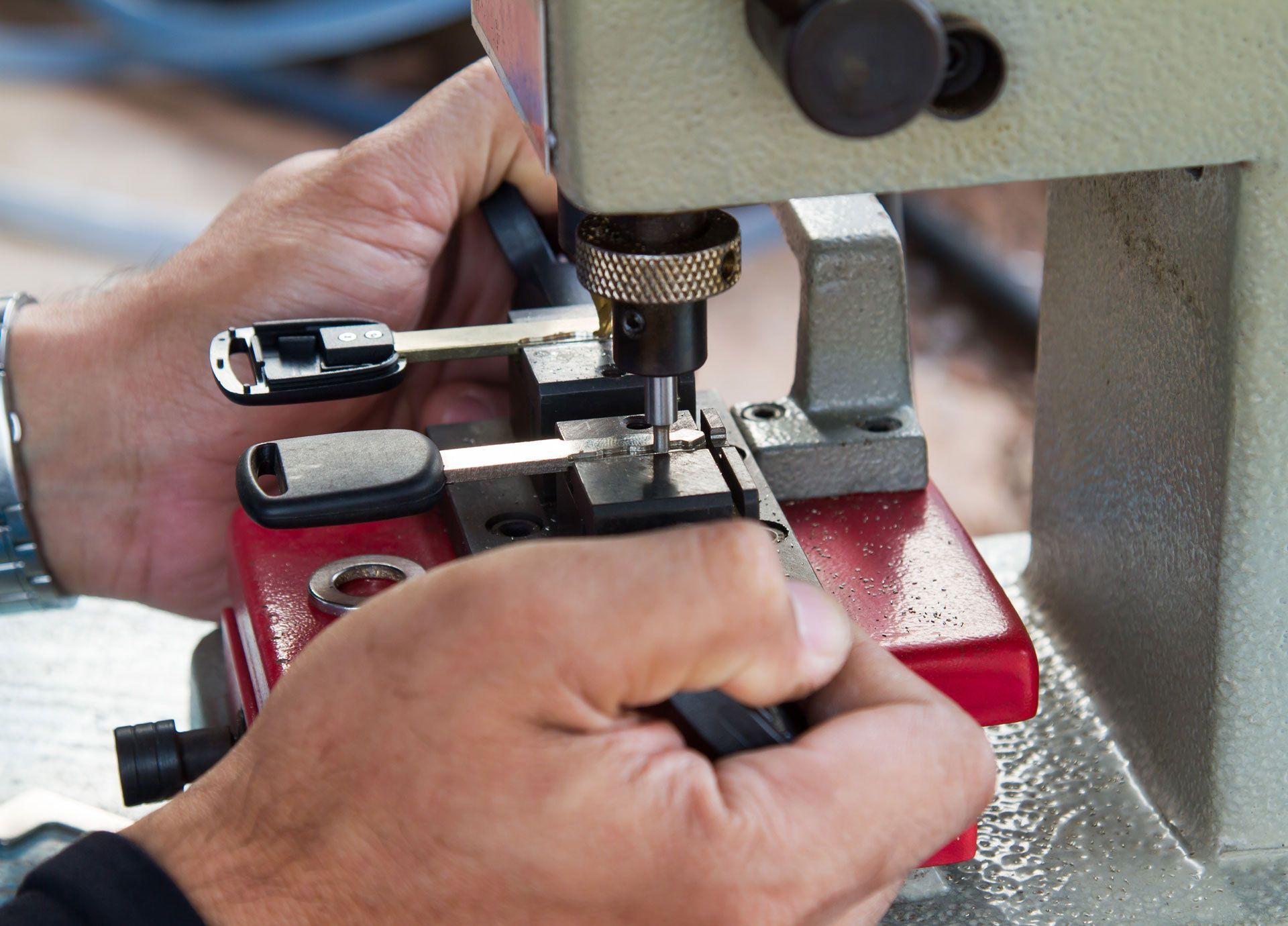 A person is cutting a key with a machine.
