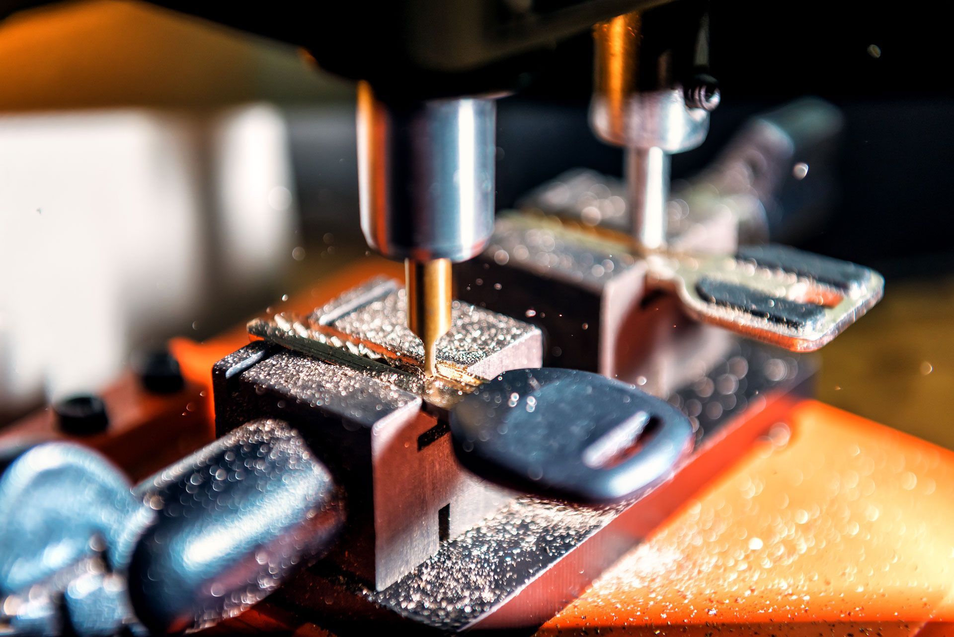 A close up of a machine cutting a key on a table.