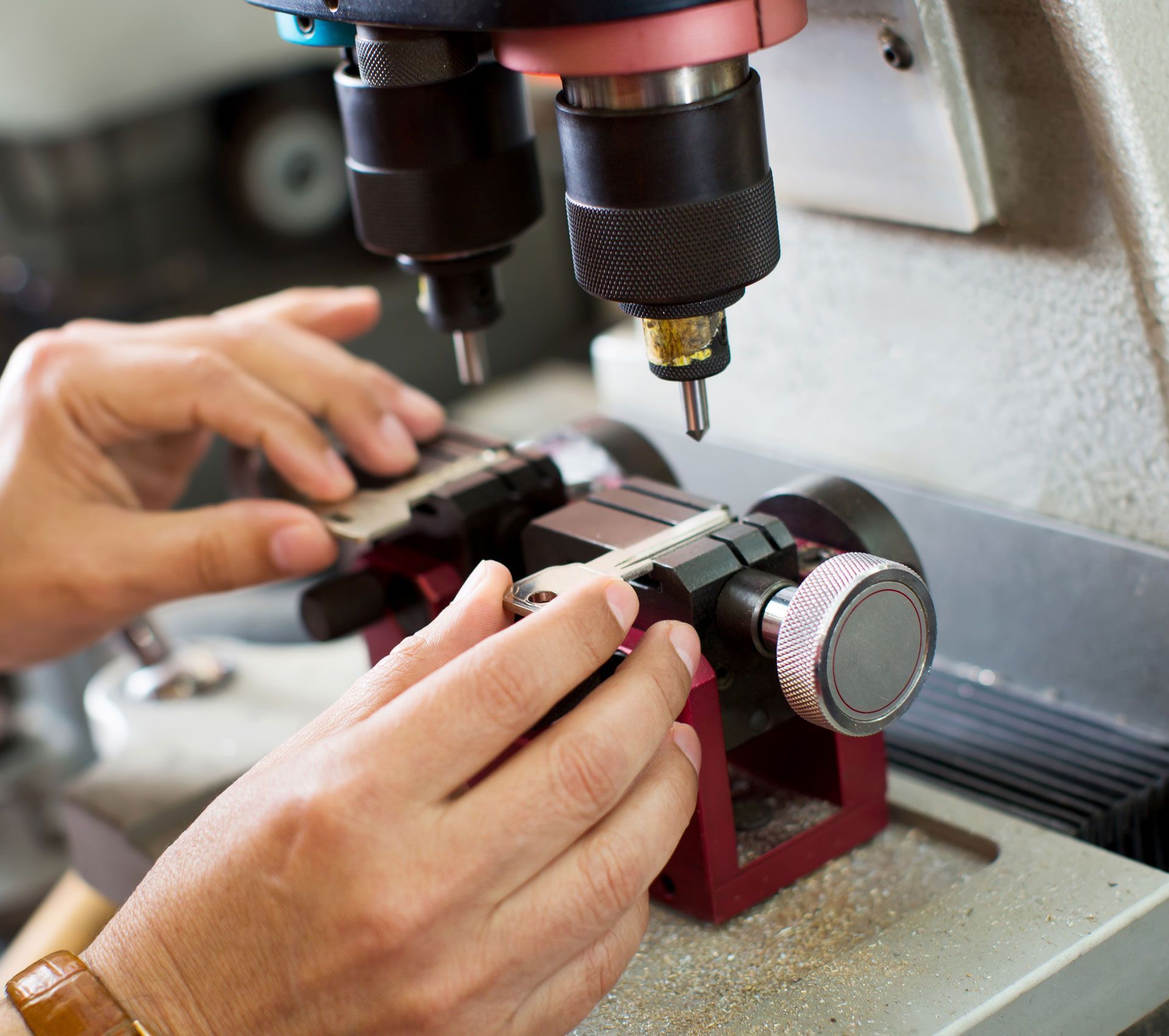 A person is using a machine to make a key
