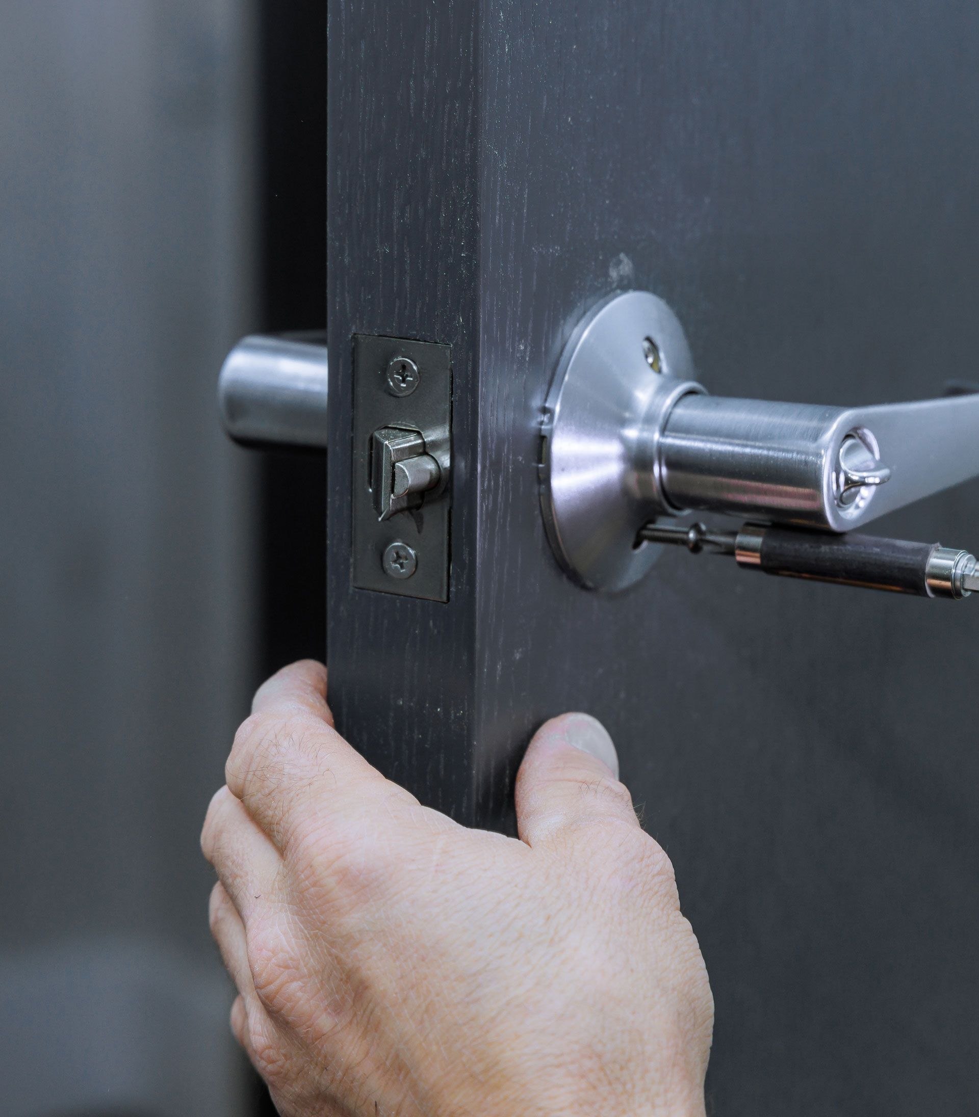 A close up of a person 's hand holding a door handle
