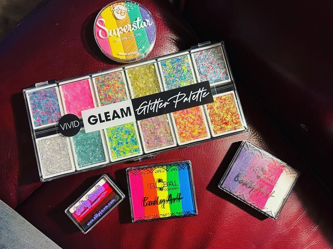 A bunch of makeup products are sitting on a table.