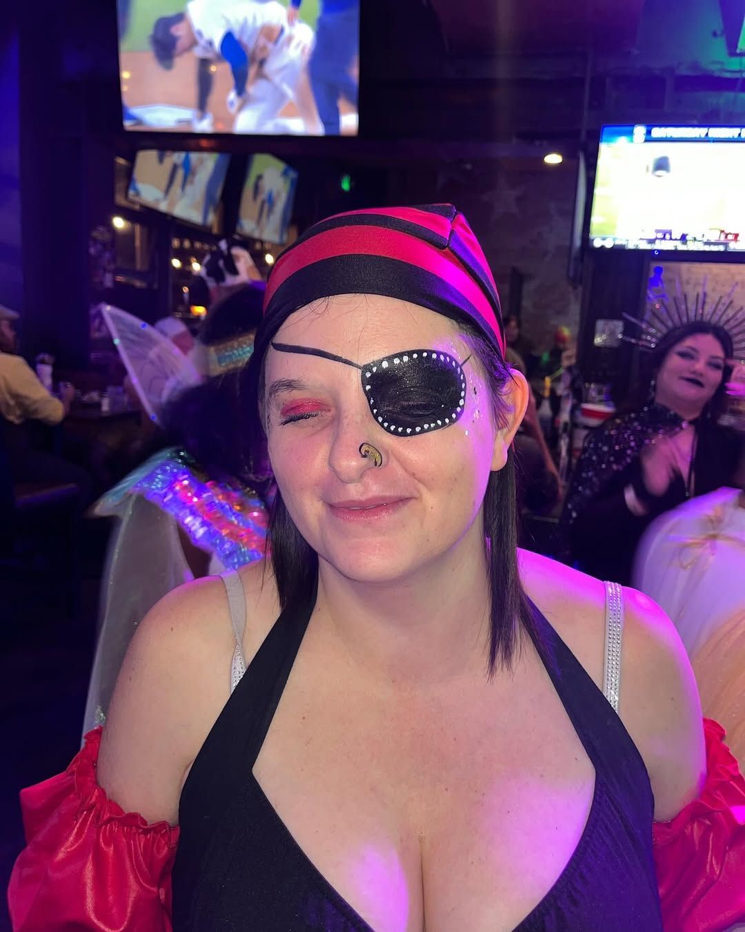 A woman in a pirate costume with an eye patch on her eye